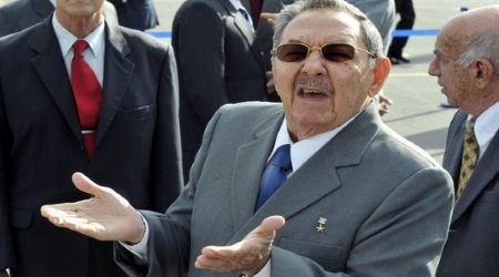 Cuban President Raul Castro gestures to the press during the farewell ceremony for China's President Hu Jintao at the Jose Marti International Airport in Havana on November 19, 2008. China's President Hu wrapped up a landmark visit to Cuba where he brought millions of dollars in aid and promises of closer trade ties. Hu also visited convalescing former president Fidel Castro, 82, with whom he held a "long conversation" and described finding him as "very recovered," according to the Chinese official Xinhua news agency.  AFP PHOTO/Juan Carlos BORJAS (Photo credit should read JUAN CARLOS BORJAS/AFP/Getty Images)
