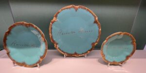 Platos con el nombre de Reinaldo Arenas en una vidriera de Tiffany & Co.
